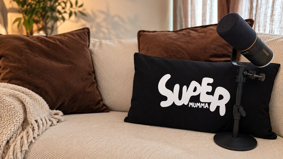 Super Mumma podcast microphone and logo on a sofa, home of honest conversations about motherhood.